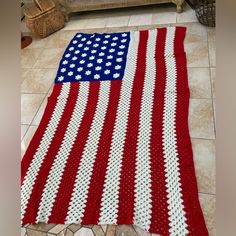 an american flag crocheted blanket on the floor