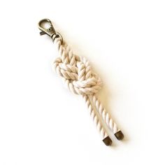 a white rope that is attached to a metal hook