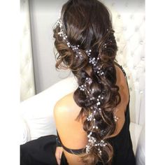 a woman sitting on a white chair with her hair in a half - up braid