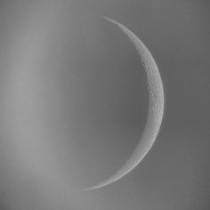 the crescent moon is seen in black and white