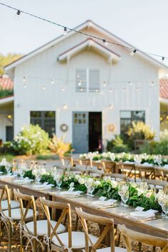 the reception table is set with white flowers and greenery for an outdoor wedding at stephanie hyffinins photography