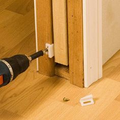 a person using a drill to fix a sliding door