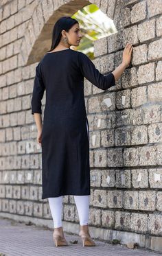 This is a single piece kurta. The kurta comes with mirror embellished has round neck, 3/4th sleeves & calf length with side slits. Single Piece Fabric-Cotton Color-Black Work-Mirror Embellished Kurta Length-Calf Length Sleeves-3/4th Sleeves Neck-Semi Collared Neck Occasion-Casual wear Washing care-Hand wash