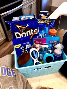 a blue basket filled with items on top of a kitchen counter