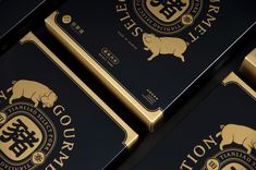 four black and gold business cards with chinese writing on the front one has an image of a pig