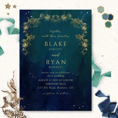 a blue and green wedding card with gold foil on it, surrounded by confetti