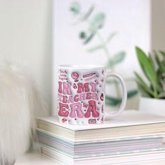 a coffee mug sitting on top of a stack of books