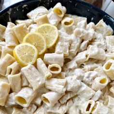 a pan filled with pasta and lemon slices