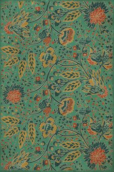 a green and orange rug with flowers on it