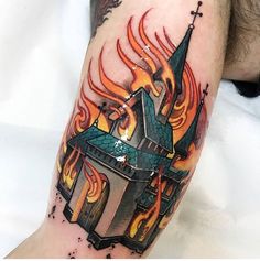 a man with a tattoo on his arm that has flames coming out of the building