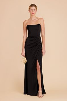 Our floor length Anne bridesmaid dress has a corset bodice, scoop neckline and high slit skirt for a flattering, timeless style. Shop Birdy Grey for this Black dress. Sure to be the dress of the season, this corset style has a flattering, minimal look. Complete with removable straps for versatile wear. | Black Bridesmaid Dress Matte Satin Size XS | Birdy Grey Anne Black Formal Velvet Dress, Black Azazie Bridesmaid Dresses, Strapless Black Tie Dress, Black Dress Flowers, Black Spring Bridesmaid Dresses, Black Bridemaid Dress, Black Bridal Party Attire Summer, Black Bridesmaid Dresses Long Elegant, Black Strapless Bridesmaid Dress