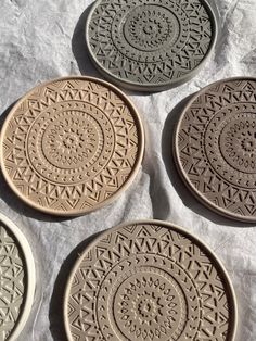 four brown plates sitting on top of a table