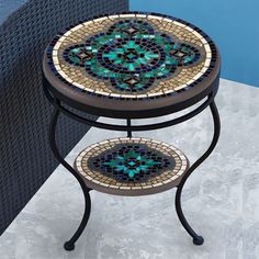 a small table with a mosaic design on the top and one section sitting on it's side