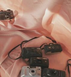 there are many different cameras on the bed