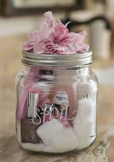 a mason jar filled with baby items on top of a table