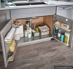 an open cabinet in the middle of a kitchen