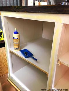 a shelf with some paint on it and a blue tool in the bottom half of it