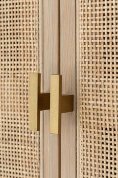 a close up of a wooden door handle on a burlocked curtain wall