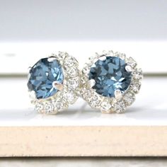 Eye-catching, classy, Sapphire Blue crystal earrings will add a little sparkle to any outfit! Swarovski's precision-cut crystals and unmatched, gorgeous colors are always show-stoppers! * Swarovski Crystals in Setting- 1/2"(13mm) * Silver-Plated Post Earrings * Nickel Free * Other colors available, don't hesitate to get in touch with us for more information These earrings come in a jewelry bag and box with ribbon. Blue Round Cluster Earrings For Wedding, Blue Earrings With Halo Setting, Classic Blue Halo Earrings, Blue Cluster Earrings For Wedding, Sparkling Blue Earrings For Gift, Blue Round Crystal Earrings For Anniversary, Blue Earrings With Sparkling Stones, Blue Rhinestone Crystal Earrings For Wedding, Elegant Sapphire Halo Earrings