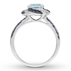 A mesmerizing display of color makes this engagement ring a truly stunning symbol of love. Ribbons of round lab-created blue sapphires and shimmering round diamonds swirl outward from the round-cut aquamarine center, while more lab-created blue sapphires decorate the band. The 14K white gold ring has a total diamond weight of 1/15 carat. From the Now + Forever® Bridal Collection. Asscher Cut Cluster Ring For Anniversary, Elegant Promise Rings With Gia Certification, Elegant Cluster Sapphire Ring, Gia Certified, Elegant Gia Certified Cluster Sapphire Ring, Elegant Gia Certified Halo Ring For Promise, Elegant Gia Certified Halo Promise Ring, Luxury Topaz Halo Ring For Anniversary, Luxury Topaz Ring With Halo Design For Anniversary, Cluster Sapphire Ring With Halo Setting For Promise