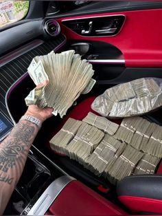 a man holding money in his car