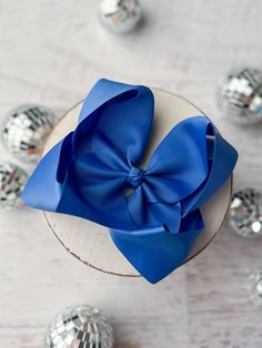 Add a pop of personality to your hair with our Oversize Size Bow - a 5.5" Grosgrain Hair Bow that's sure to make a statement. In 20+ Bold, bright, and oh-so-playful colors, this oversized bow will bring a touch of quirkiness to any outfit. Take your style to the next level with this large hair accessory! How big is my bow? Approx: 5.5" height x 5" width Ribbon Size: 2.25" Clip Type: Single Prong Alligator Clip Classic Blue Bow With Butterfly Knot, Classic Adjustable Red Bow, Diy Tutu Skirt, Adjustable Blue Bow Hair Accessories, Blue Hair Bows, Large Hair Bows, Big Hair Bows, Blue Adjustable Bow Hair Accessories, Diy Tutu