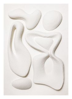 three white sculptures are arranged in the shape of an abstract woman's head and torso