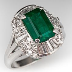 This shimmering ring is centered with an emerald cut emerald, weighing 2.57 carats, in a four-prong setting. The emerald is surrounded by eighteen (18) channel set tapered baguette cut diamonds, and twenty-eight (28) prong set round brilliant cut diamonds. The ring measures 16.0mm at the top, rises 10.5mm above the finger, tapering to 2.5mm wide and 1.1mm thick at the base of the shank. The ring is crafted in platinum and is currently a size 7. Luxury Emerald-cut Channel Set Sapphire Ring, Formal Octagon Emerald Diamond Ring, Elegant Green Octagon Diamond Ring, Gia Certified Formal Emerald Cut Emerald Ring, Formal Platinum Emerald-cut Emerald Ring, Formal Platinum Emerald Cut Emerald Ring, Formal Emerald-cut Platinum Emerald Ring, Exquisite Gia Certified Emerald Cut Emerald Ring, Octagon Emerald Ring With Diamond Accents For Formal Events