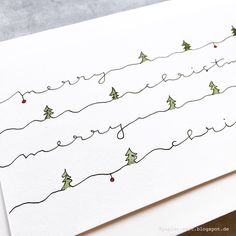 a handwritten christmas card with trees on it