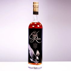 a bottle of eagle rare whiskey sitting on a table