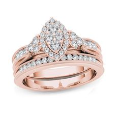 a rose gold wedding ring set with two pear shaped diamonds