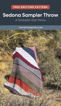 a crocheted blanket sitting on top of a field