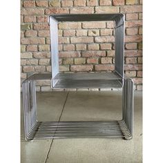 a metal shelf sitting in front of a brick wall