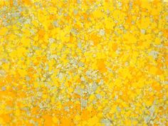 an abstract yellow background with white and gray speckles