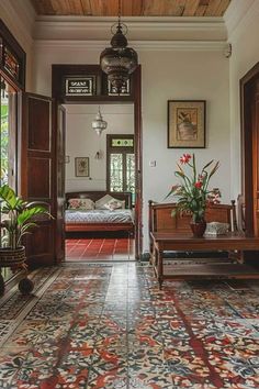 a living room filled with furniture and lots of plants on top of a tiled floor