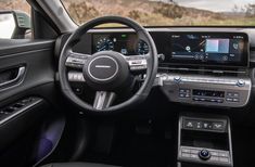 the interior of a modern car with dashboard and infotain, including touchscreens