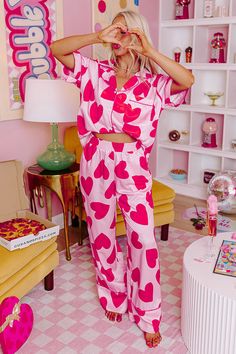 - Get your beauty sleep in these sweet pajama pants! - Unlined material with a pink heart print and accent piping - An elastic waistline - Functional side pockets - A relaxed silhouette that ends in straight hemline Satin Pajamas Set, Satin Pajama Pants, Top With Pants, Short Loungewear, Heart Valentines, Beauty Sleep, Chiffon Material, Satin Pajamas, Plus Size Sweaters