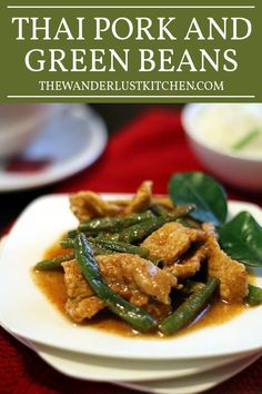 thai food with meat and green beans on a white plate