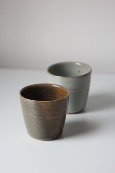 two cups sitting next to each other on a table