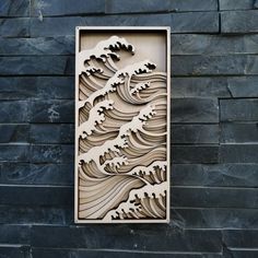 a wooden cutout of waves on a stone wall