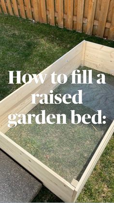 a wooden bed frame sitting on top of grass in a yard next to a fence