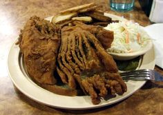 a white plate topped with meat and cole slaw