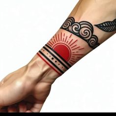 a person's arm with a red sun and clouds tattoo on the left wrist