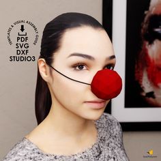 a woman with a red nose and nose piece on her head, in front of a photo