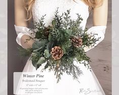 a woman in a white dress holding a bouquet with pine cones and greenery on it