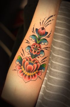 a woman with a flower tattoo on her arm