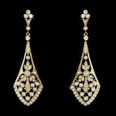 two pairs of gold and diamond earrings, one with an intricate design on the side