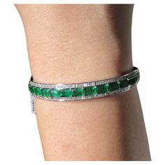 The Following Item we are offering is a Rare Magnificent Radiant 18KT Gold Large Rare Gorgeous Fancy Emerald and Diamond Bangle Bracelet. Bracelet is comprised of Beautiful Glittering Emeralds Framed with Gorgeous Glittering Diamonds!!! T.C.W. Approx 11CTS!!! This Gorgeous Bangle is a Rare Sample New With Tags from a Private Manufacturer that sold to Important 5 Star Hotel and Fine Jewelry Stores. NWT Price: $22,800.00!! Elegant Diamond Gemstone Bracelet For Party, Luxury Green Cuff Bracelet For Formal Occasions, Luxury Cuff Bracelet With 17 Jewels For Anniversary, Elegant Green Cuff Bracelet For Formal Occasions, Green Diamond Bangle Bracelet For Formal Occasions, Elegant Gemstone Cuff Bracelet For Anniversary, Formal Green Diamond Bangle Bracelet, Luxury Bracelets With Single Cut Diamonds For Party, Luxury Party Bracelets With Single Cut Diamonds