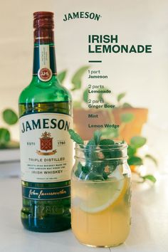 a bottle of jameson lemonade next to a mason jar