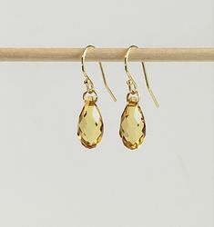 "- Striking Yellow Gold Earrings in Prestige Faceted Crystal Golden Topaz 13mm Teardrop Briolettes. See Photos #1-4. - Stunning piece has many Facets to capture the light in Gold, Honey and Yellow hues. - 14K Gold Filled Jump Ring Connectors now in petite 4.5mm size. - 14K Gold Filled Bali Ear Wire with petite Ball Ends.  - 14k Gold Filled Posts/Studs with 3mm Ball Ends, with 14K Gold Filled Push Backs, Listed separately. See Photo #5. - 14K Gold Filled Lever Backs Listed separately. See Photo # Gold Briolette Earrings, Gold Briolette Crystal Earrings With Ear Wire, Gold Briolette Crystal Earrings For Pierced Ears, Gold Drop Earrings With Faceted Details, Yellow Gold Faceted Briolette Earrings, Classic Gold Drop Crystal Earrings, Gold Hypoallergenic Briolette Earrings, Hypoallergenic Gold Briolette Earrings, Hypoallergenic Yellow Gold Briolette Earrings